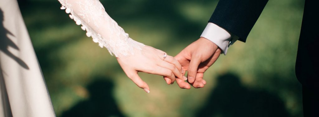 Just married couple holding hands